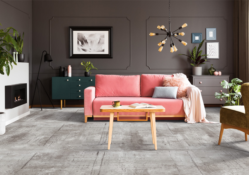 gray patterned carpet in living room with pink couch and maximalist decor